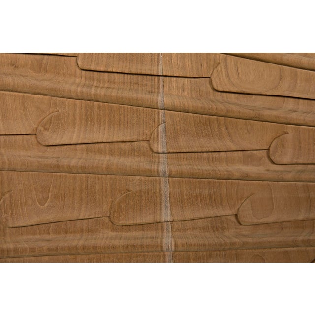 Hand-carved of teak and mahogany, the doors of This mid-century modern sideboard feature exquisite starburst carvings and...