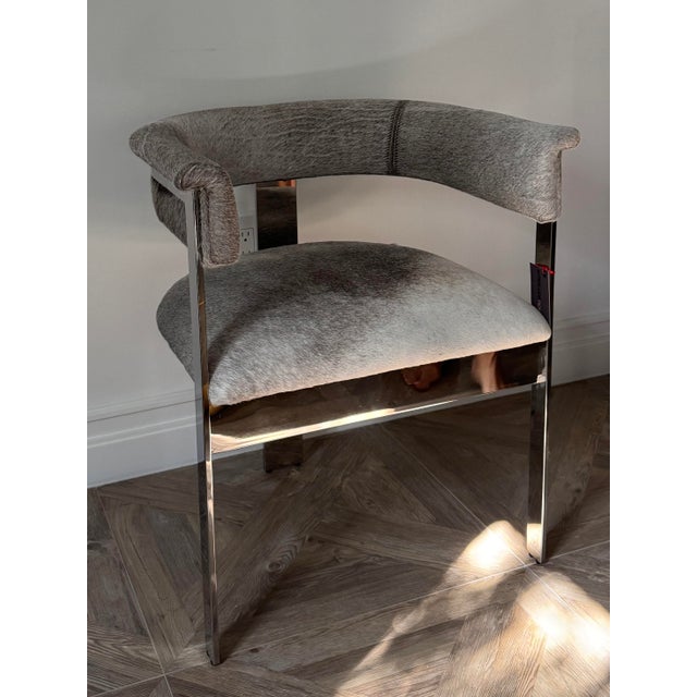 This chair is a modern beautiful clean lines piece. New condition. Perfect as a statement piece. Hide fabric with...