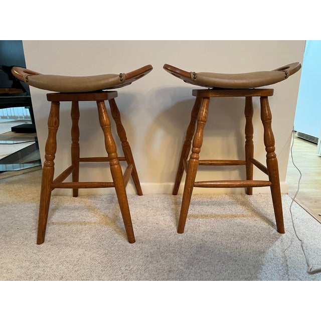 2000 - 2009 Vintage Swivel Wooden Saddle Stools 27” - A Pair For Sale - Image 5 of 6