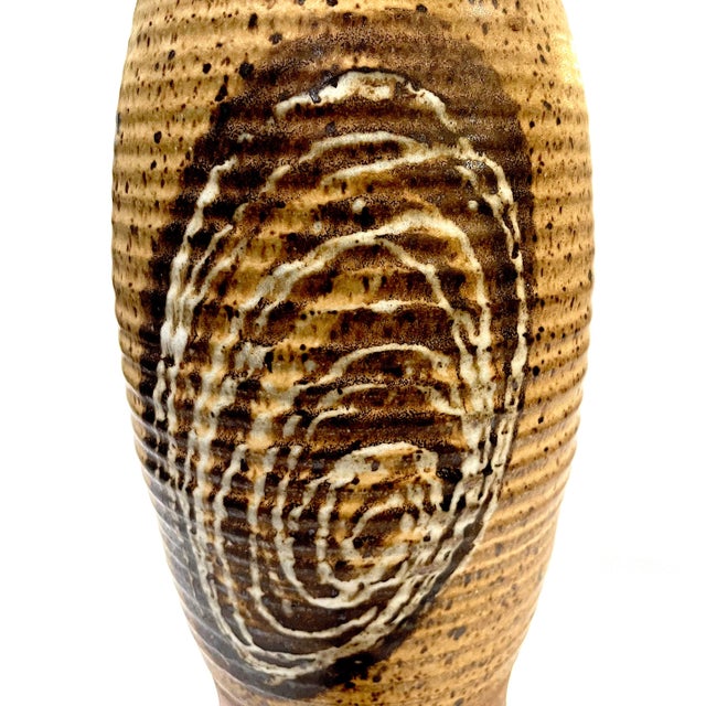 Charming yet useful 1980's wine jug. Hand-crafted of salt glazed stoneware pottery in a range of tan and brown hues....