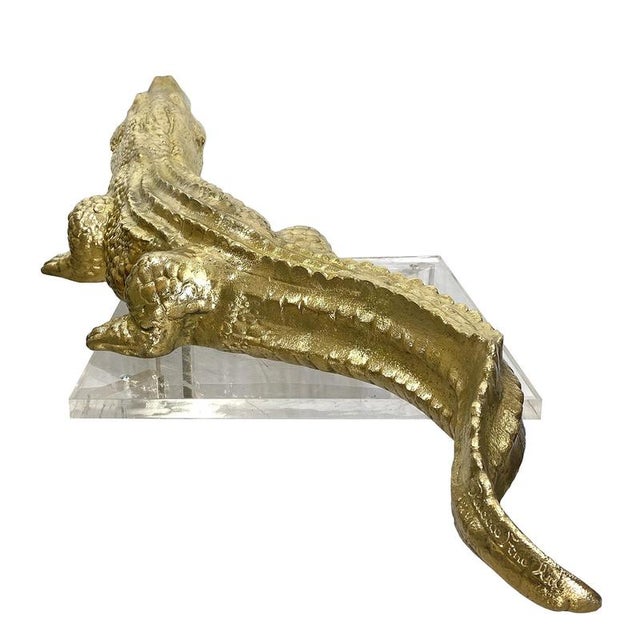 Dimensions: 22 x 34 x 104 cm Brushed brass A sinuous crocodile whose undulating movement creates an elegant silhouette....