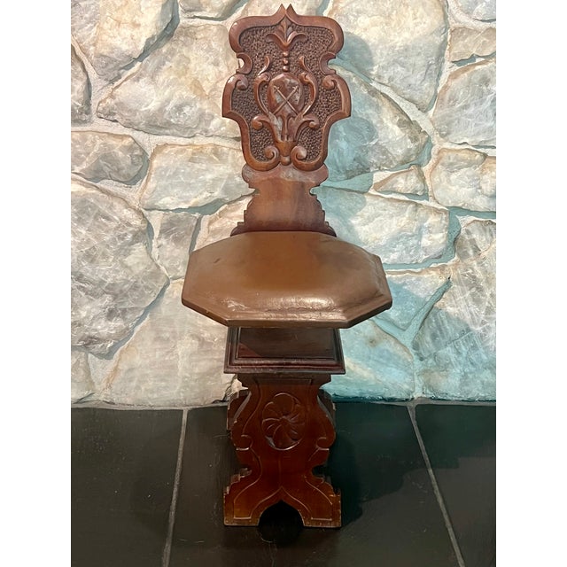 A striking antique Spanish Renaissance Revival "Sgabello" hall or accent chair. Masterfully crafted from richly grained...