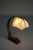Hand-forged wrought iron desk lamp with original parchment lamp shade. The shade has a bit of heat damage to the top. The...