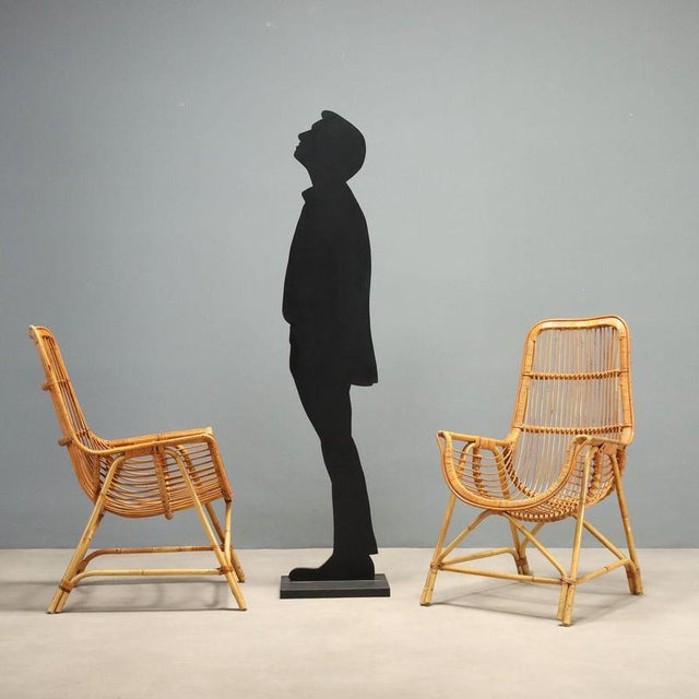 Rattan and bamboo armchairs crafted in the 1970s, perfect for furnishing interiors or verandas with a vintage touch. The...