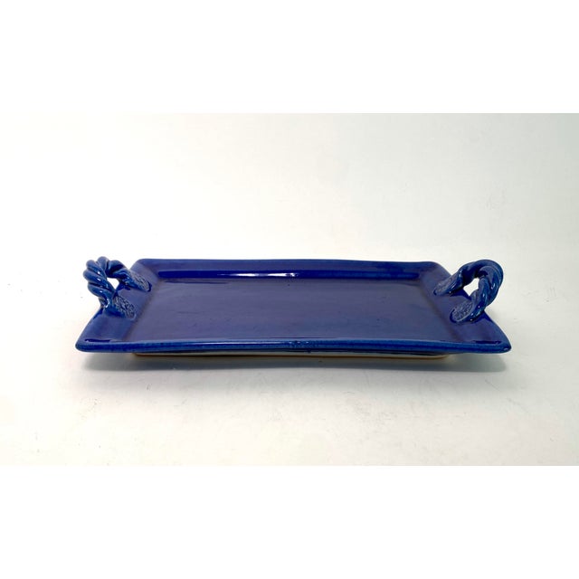 Smaller Italian pottery oblong tray with twisted rope handles is a brilliant glazed blue that could be used in serving or...