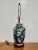 1970’s Vintage Asian-inspired ceramic ginger jar table lamp with hand-painted floral décor and wood base. Tested and...