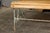 A French rustic, painted iron garden bench from the 19th century with scrolling motifs on the back, curving slatted seat...