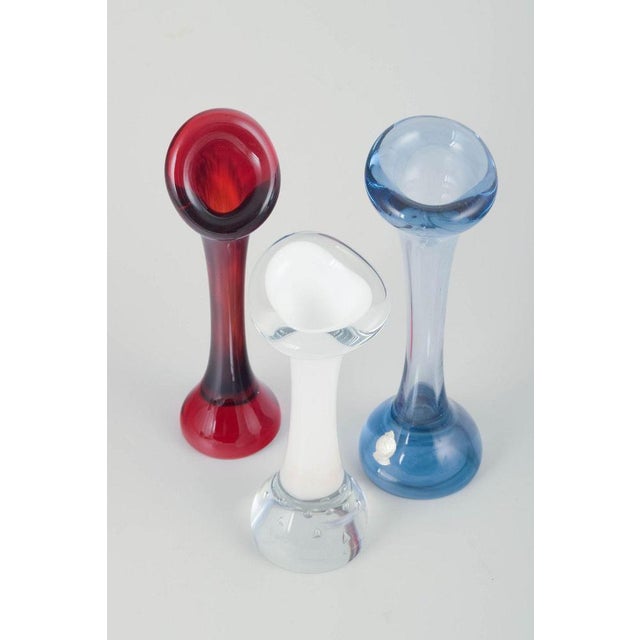Mantorp Glasbruk & Skånska Glasbruket. Set of three sculptural glass vases. Mouth-blown glass in red, blue and opaline...