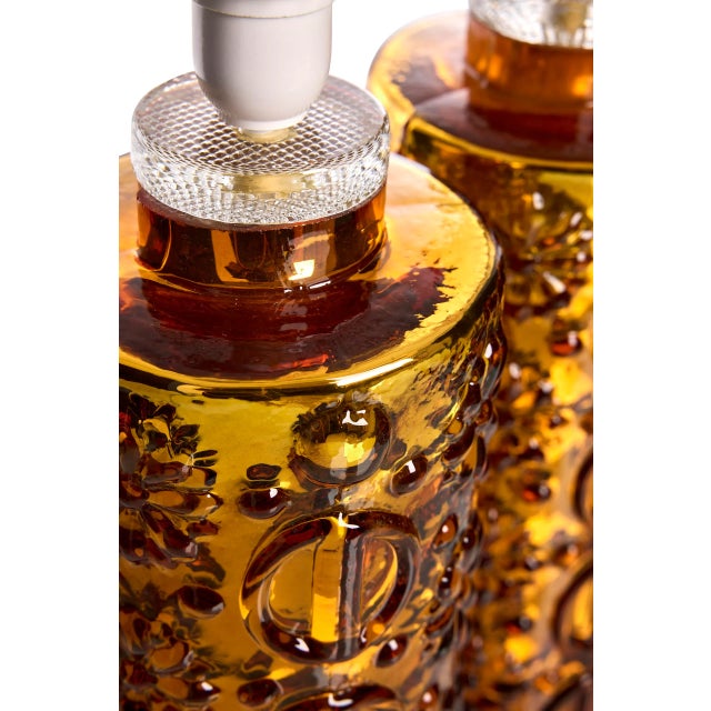 Illuminate your home with the captivating glow of these exquisite glass table lamps, masterfully crafted by the renowned...