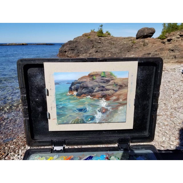 This oil painting captures a vibrant coastal scene at Presque Isle, where rocky formations meet the shimmering water. The...