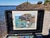 This oil painting captures a vibrant coastal scene at Presque Isle, where rocky formations meet the shimmering water. The...