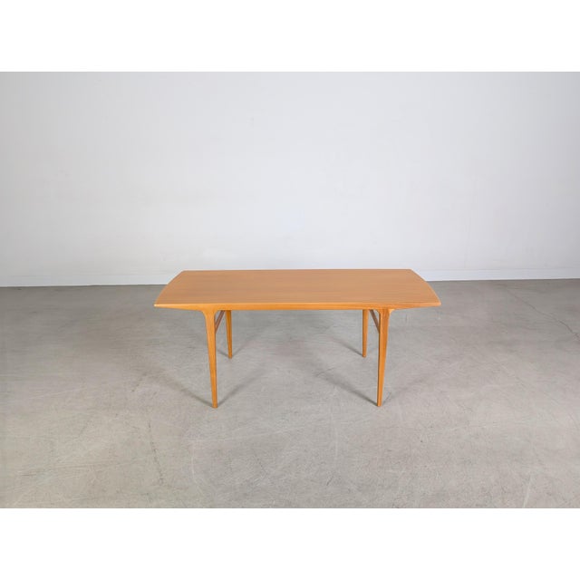 We are offering an authentic vintage pecan wood coffee table for sale. The design is reminiscent of Johannes Andersen's...