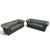 English Chesterfield sofas upholstered in rich dark green leather, featuring deep button tufting, classic rolled arms, and...