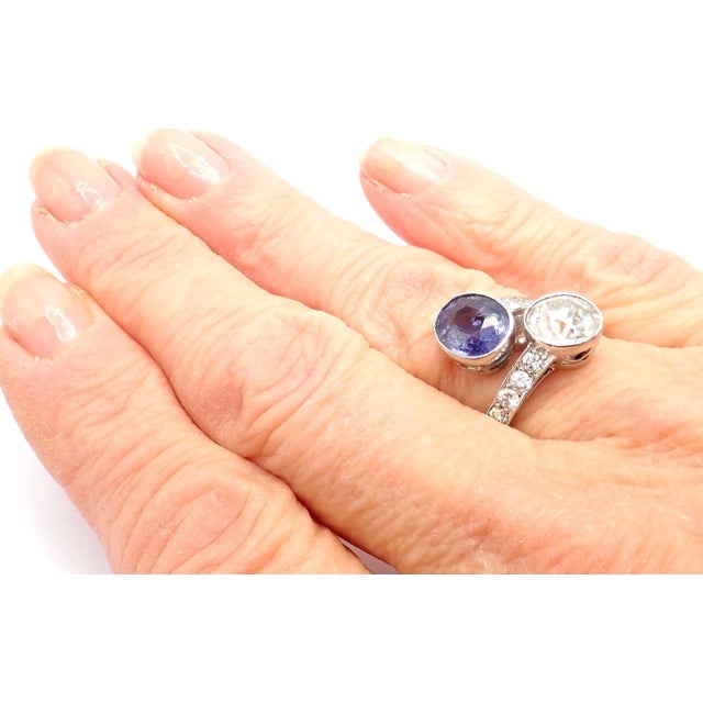 This vintage estate Art Deco ring features a round old European diamond and round sapphire, accented by diamonds on both...