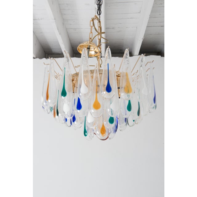 1960s new old stock modern style Murano chandelier with 9" glass drops. The clear drops are infused with large dramatic...