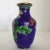 Here are a pair of deep blue cloisonné vases decorated with traditional Chinese wealth flowers. One of the vases has a...