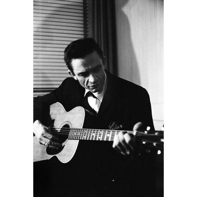 Johnny Cash At The New York Folk Festival NEW YORK - JULY 1965: Country singer Johnny Cash warms up backstage at the New...