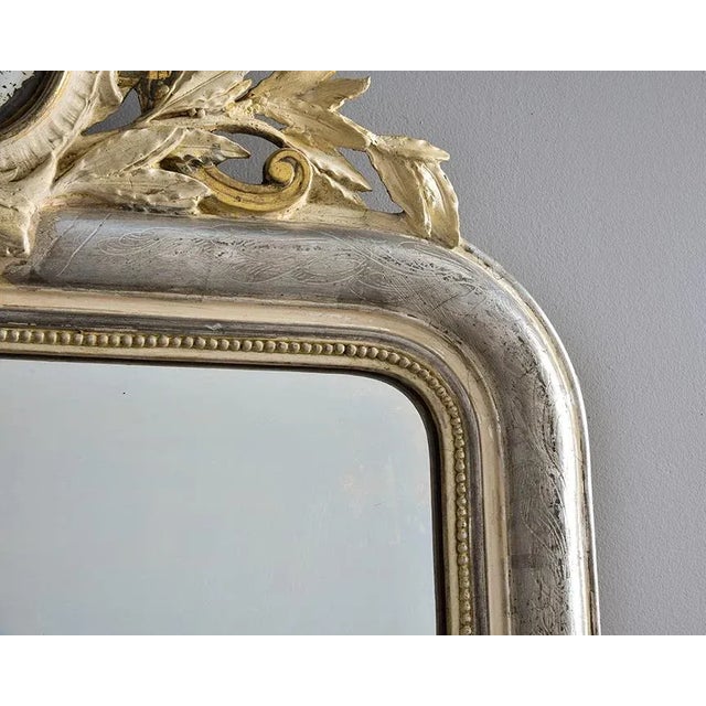 Found in France, this large Louis Philippe mirror dates from the 1870s. Silver gilt frame has subtle etched design of...