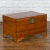 A Chinese late Qing Dynasty period refinished pine chest from the early 20th century, with carved feet and brass hardware....