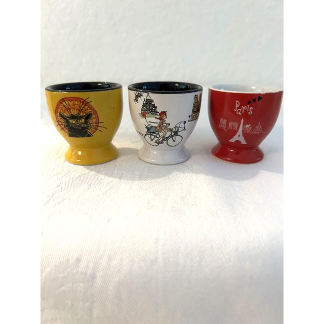 Cute set of five ceramic egg cups each in a different Parisian motif. Marked underside "NEM." Great condition.