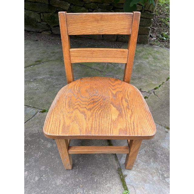A solid oak wood child's chair . Well constructed and sturdy.