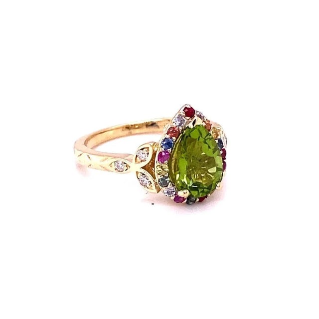 2.52 Carat Natural Peridot Sapphire Yellow Gold Cocktail Ring This beautiful ring has a Pear Cut Peridot in the center...
