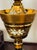 Large antique Bohemian cut amber glass with gold and enamel compote on stem foot with cover.