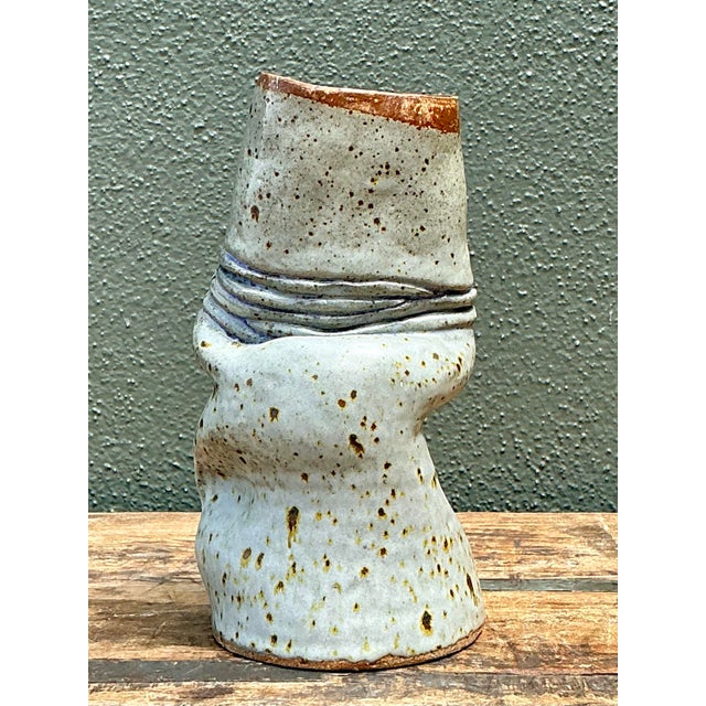 Highlighting the sculptural freedom of mid-century studio pottery, this vintage ceramic vase captures a captivating...