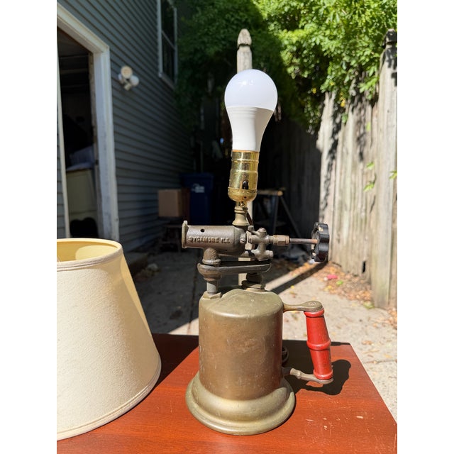 Turner Brass Works blowtorch converted into a functional table lamp. Original brass/bronze body with red wood handle and...
