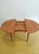 A vintage Danish teak extendable table from the 1960s with an elegant round extension system, perfect for a versatile and...