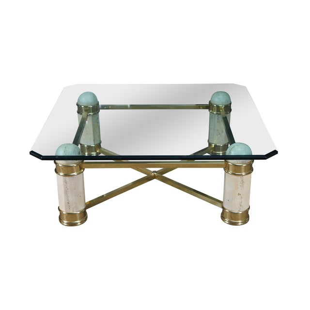 A stately Italian Regency Coffee Table, circa 1980s. Features a beveled glass top with canted corners supported by a...