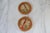 Vintage feather art bird wall hangings with hand painted foliage and convex glass. No makers mark.
