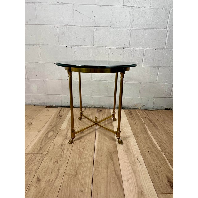 Elegant vintage Neoclassical gueridon or side table featuring a finely detailed brass frame and a substantial round...
