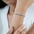 The Handmade 9.1 Ct Rainbow Moonstone Infinity Line Bracelet features a graceful row of round rainbow moonstones set in...