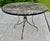 This is a very classic and good looking round outdoor or patio table with a hole for an umbrella and spider legs. It is in...
