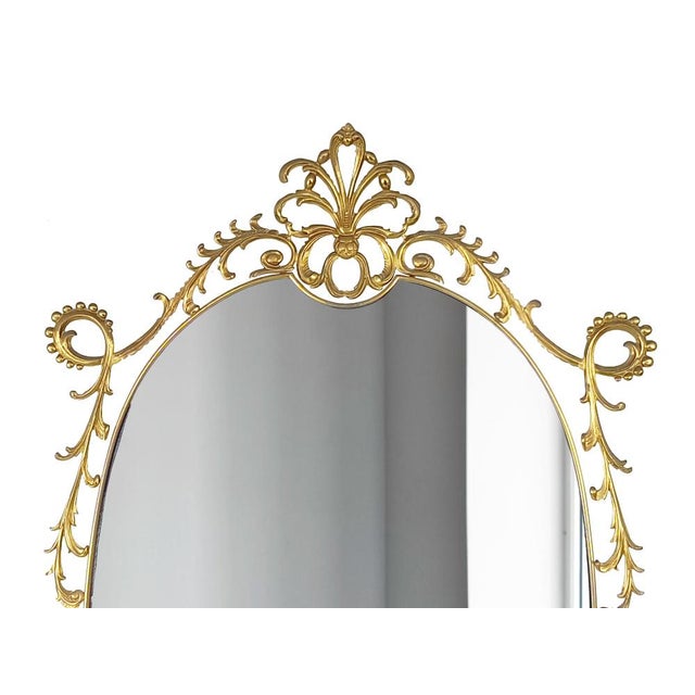 This large smoked glass wall mirror was produced in Italy in the 1960-70s. A decoration of scrolls and volutes in the...