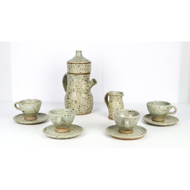A 10-piece stoneware coffee service by Gustave Tiffoche, circa 1970. Comprising a filter coffee maker (see photo), a milk...