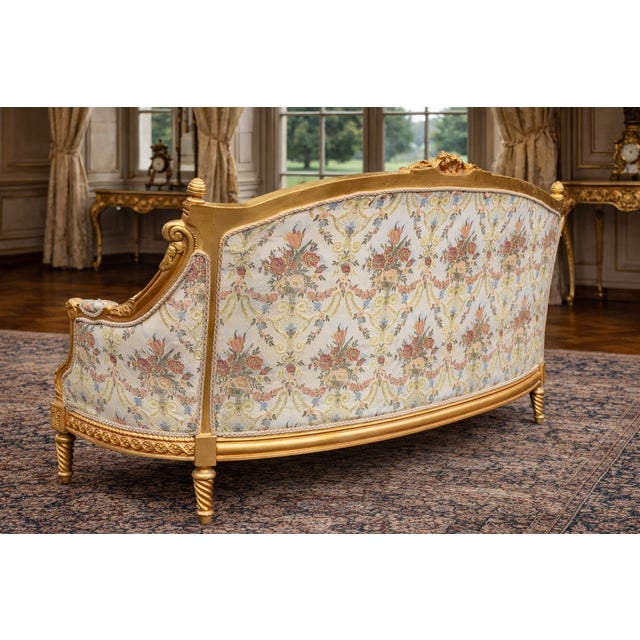 A romantic 1980 French Louis XVI–style settee, handcrafted from solid beechwood and finished in an elegant antique gold...