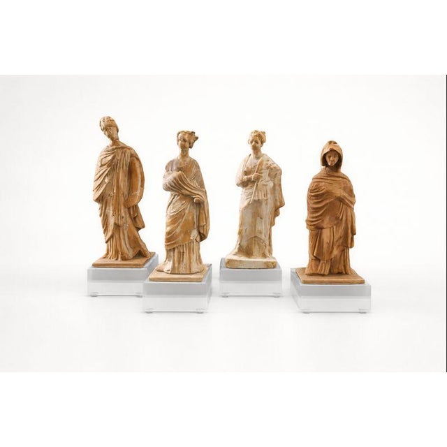 A refined set of four Italian terracotta female figures, dating to the late 19th century, created in the Grand Tour...
