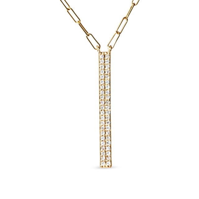Draped in the opulence of 14K yellow gold, this exquisite necklace intertwines two distinct strands, each shimmering with...