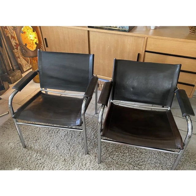 Pair of armchairs, Klinte model, Tord Bjorklund for Ikea Sweden 1980. Tubular chrome steel frame with brown leather...