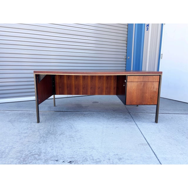 Embodying the clean architectural principles of modernist office design, this vintage executive desk is styled in the...