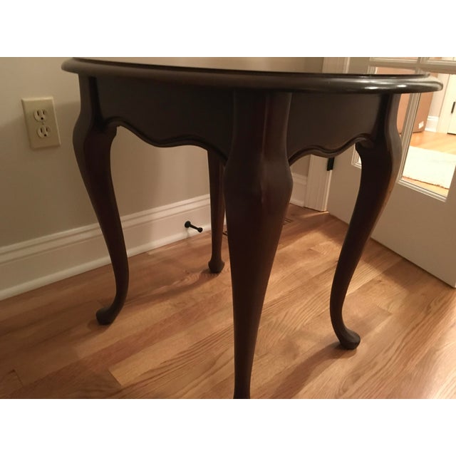 Cherry oval-shaped side/end/accent table with 4 cabriole legs.