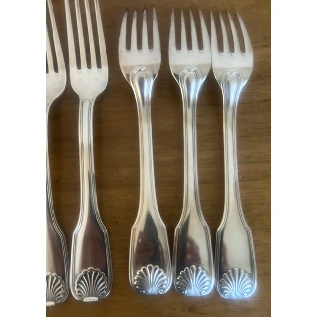 Set of 37 pieces of French silverplated shell pattern flatware, each piece hallmarked by the maker Frionnet Francois....