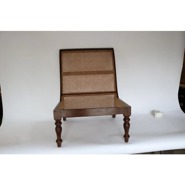 Teak wood chair with ratan back and seat. Low chair with wide seat.