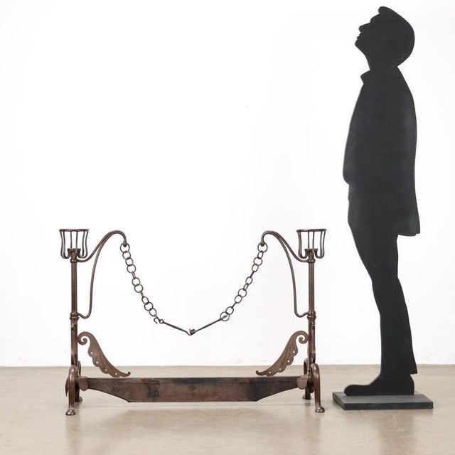 Wrought iron fireplace andiron. This piece is attributed to the mentioned designer/maker. It has no attribution mark and...