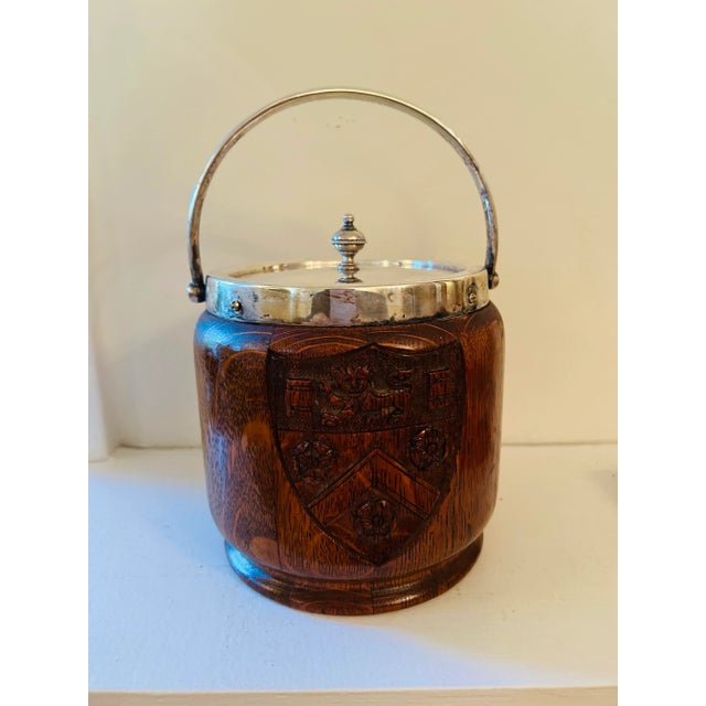 English Silver-plate barware ice bucket lined with porcelain, hand carved coat of arms on one side and silver coat of arms...