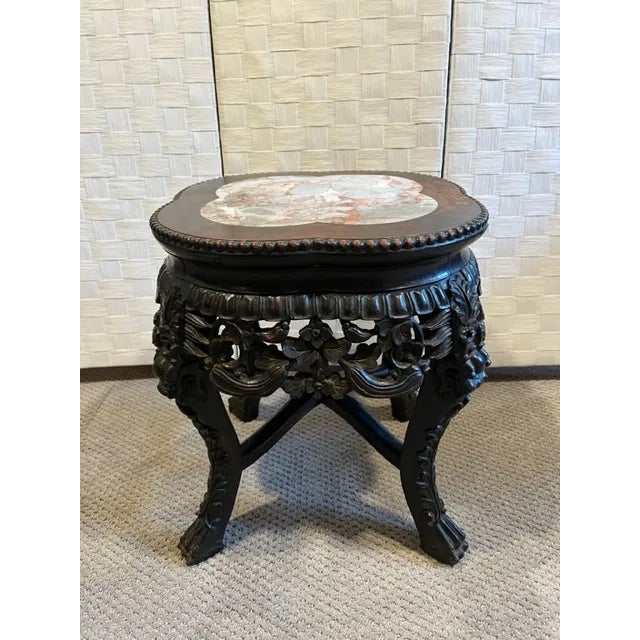 Chinese carved rosewood low occasional table/end table/plant stand. Table has an inset marble top and profusely carved...