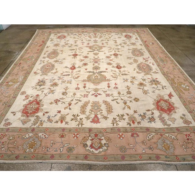 A wool pile of symmetric knots on a cotton foundation. This is a basically three-column design on an ecru-straw field,...
