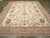 A wool pile of symmetric knots on a cotton foundation. This is a basically three-column design on an ecru-straw field,...
